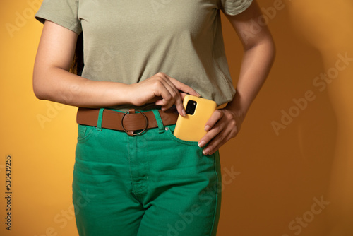 The girl puts the phone in her pocket