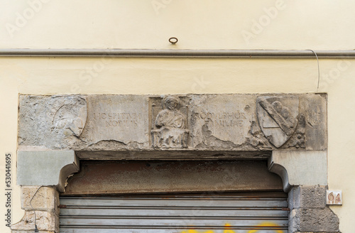 Architrave with bas reliefs of coat of arms, former hospital of San Pier Novello, built in 14th century, in via Romana (Roman street), Florence city center, Tuscany region, Italy photo