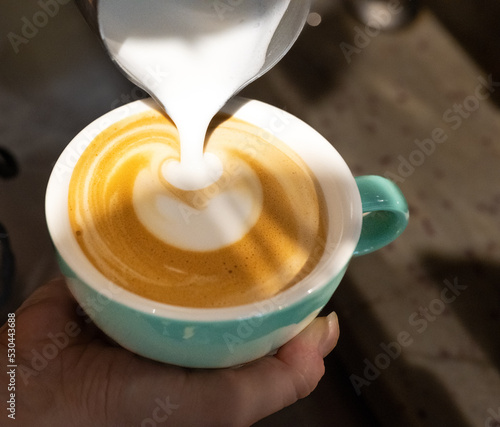 pouring milk into a cup