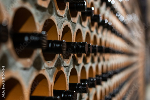 Archive of red wine with black corks in the wine cellar in special brick openings. Bela Krajina, Slovenia