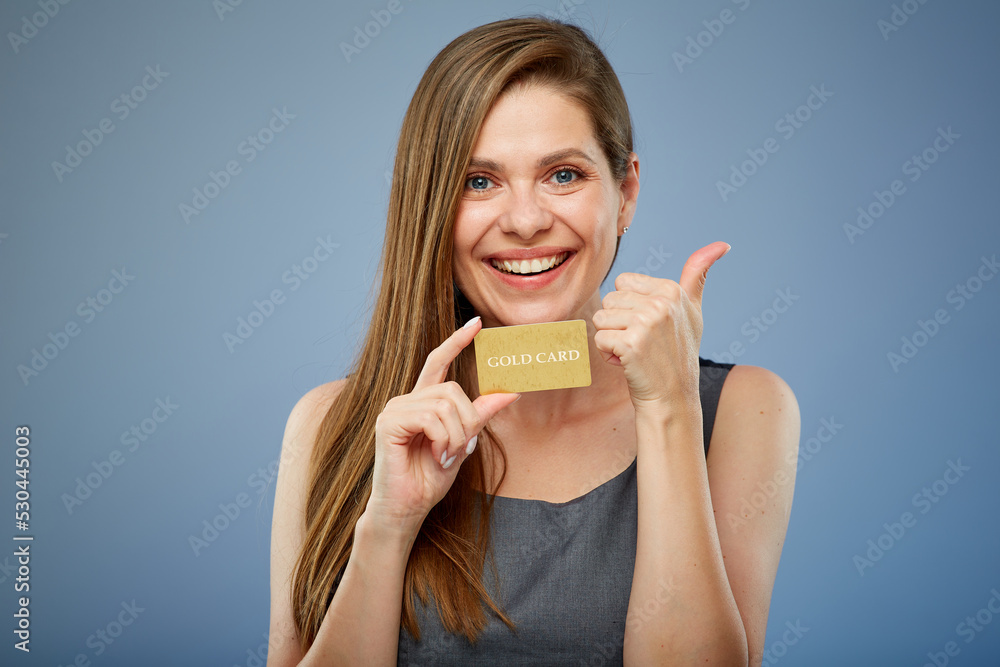 Woman smilng and holding gold credit card. isolated portrait with thumb up. Woman smilng and holding gold credit card. isolated portrait with thumb up.