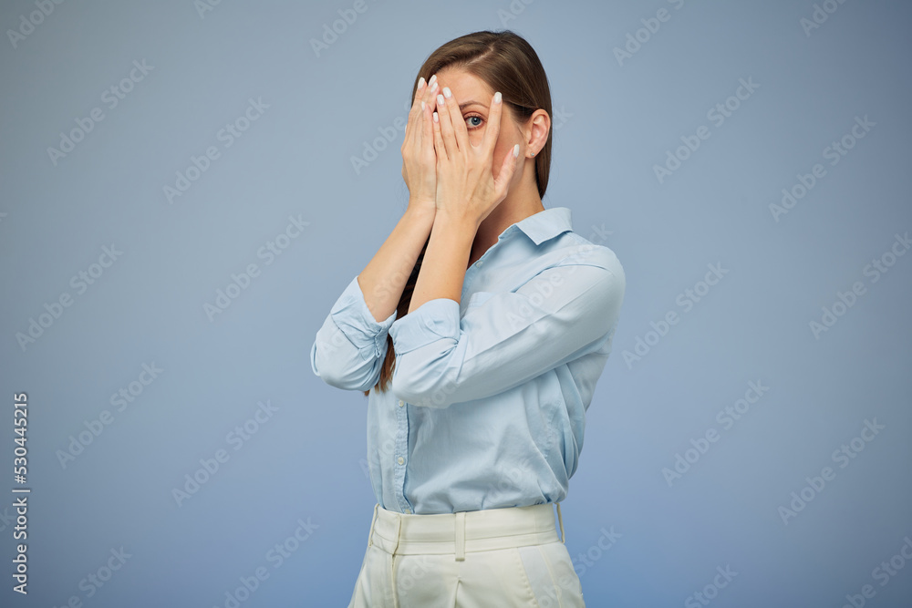 Woman hide her face with hands. isolated female portrait on blue. Woman hide her face with hands. isolated female portrait on blue.