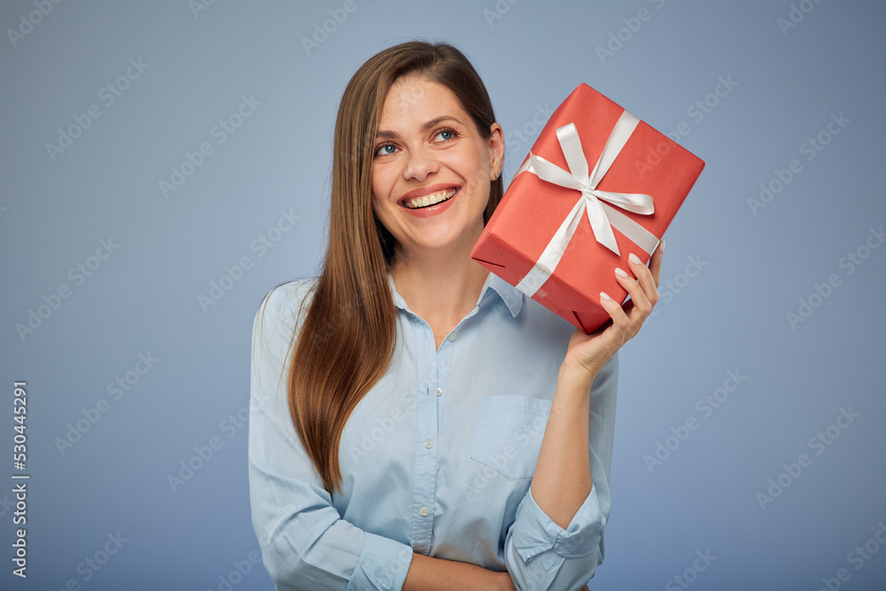 Happy woman holding gift box looking up. Isolated female portrait. Happy woman holding gift box looking up. Isolated female portrait.