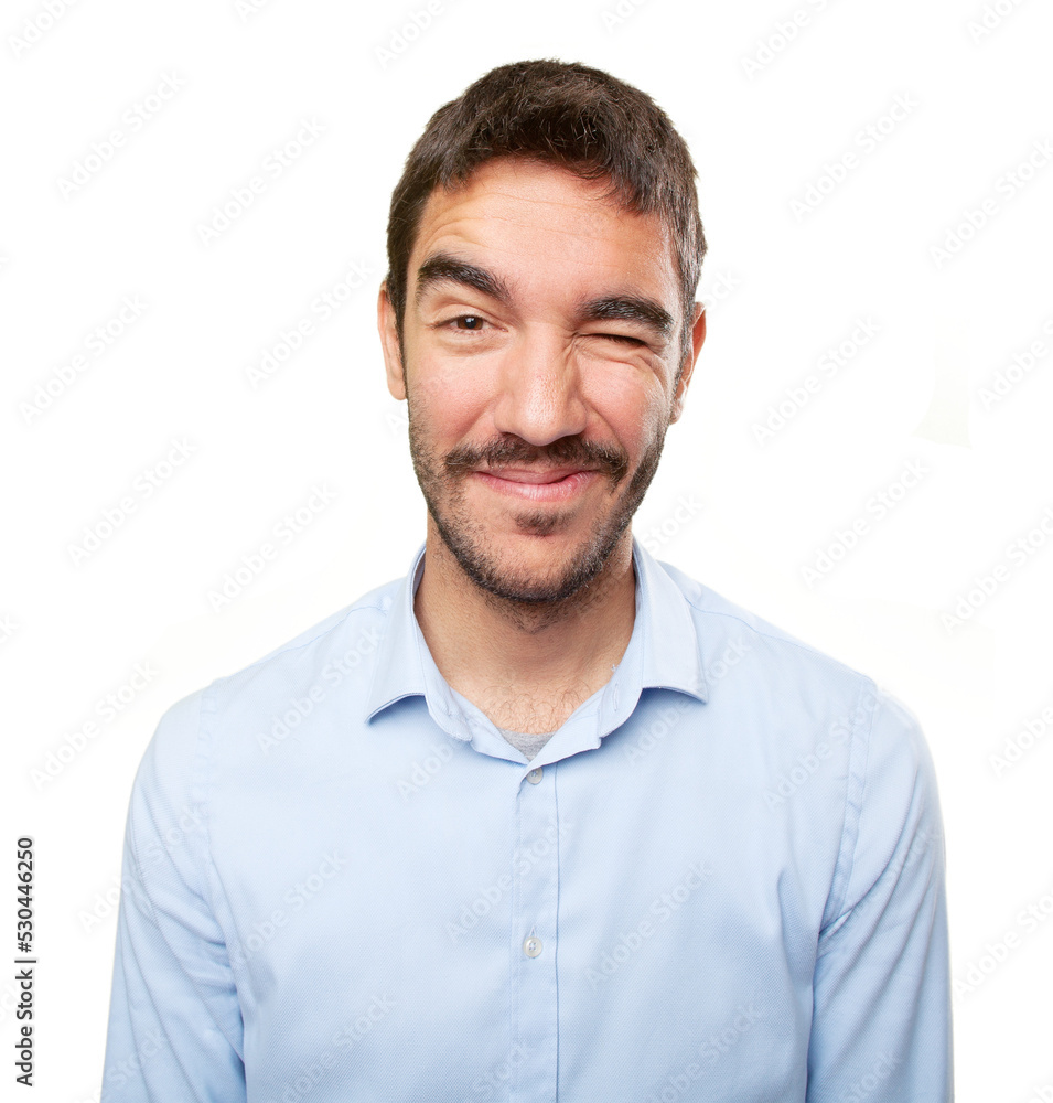Close up of a young man winking an eye Close up of a young man winking an eye