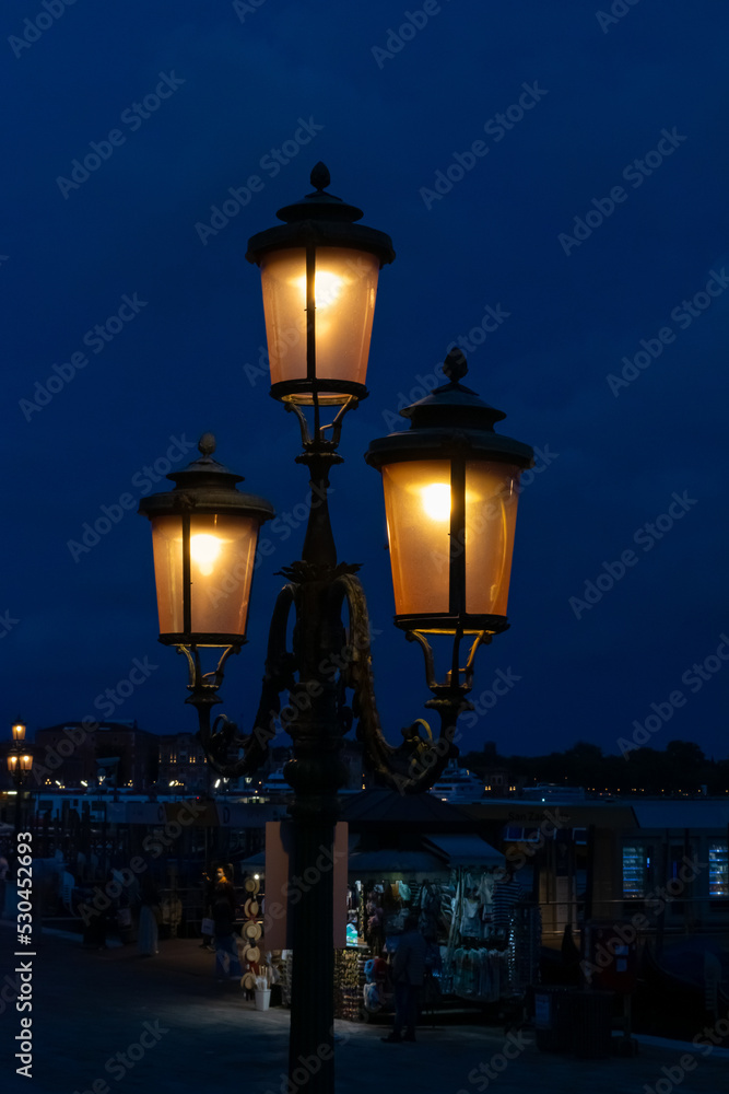 Romantic scene created by street lights at night along the grand canal in Venice Italy