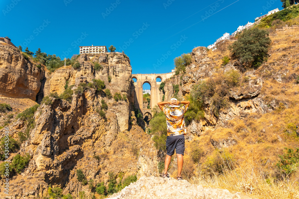 A young tourist visiting the new bridge viewpoint in Ronda province of Malaga, Andalucia A young tourist visiting the new bridge viewpoint in Ronda province of Malaga, Andalucia