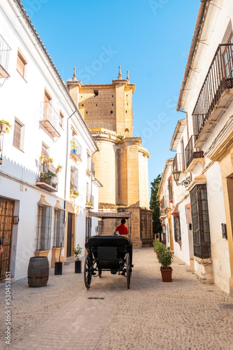 Carriage with tourists next to the Church of Santa Maria la Mayor in the historic center of Ronda  Malaga