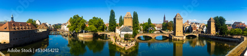 Picturesque panoramic view of Strasbourg cityscape overlooking Ponts Couverts with four towers seen from viewing terrace of Barrage Vauban on sunny summer day, France © JackF