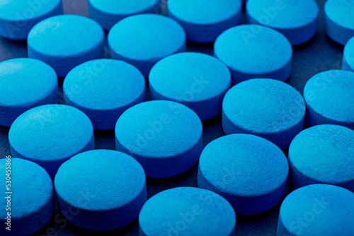 Blue tablet background, drug roofie ox extasy