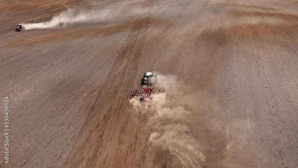 Soil cultivation field use tractor. Disk harrow on plowing field. Cultivated land and soil tillage. Tractor with disc cultivator on land cultivating. Tractor disk harrow on field cultivation. Soil cultivation field use tractor. Disk harrow on plowing field. Cultivated land and soil tillage. Tractor with disc cultivator on land cultivating. Tractor disk harrow on field cultivation.
