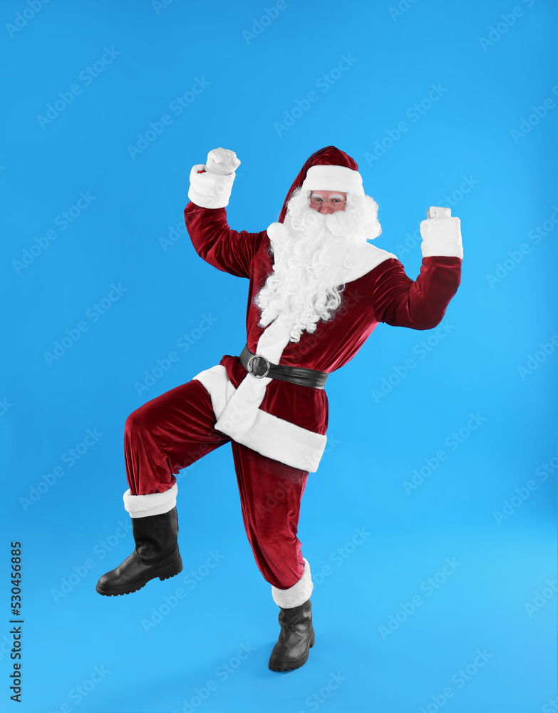 Full length portrait of Santa Claus on light blue background Full length portrait of Santa Claus on light blue background