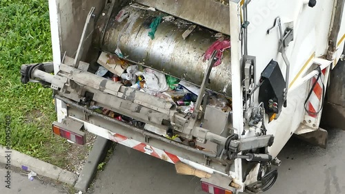 Garbage truck working - removal of mixed domestic waste, closeup stock video, Moscow, 9 Sept 2021