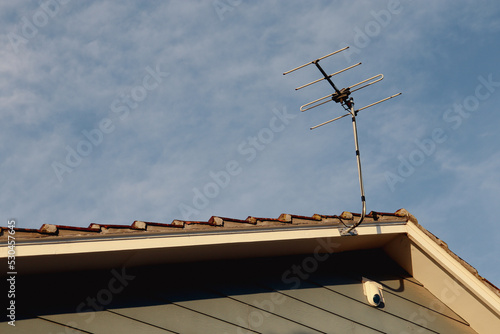 television antenna and alarm on roof of house
