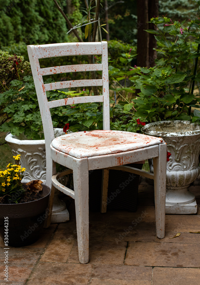 bloody white chair in a garden 