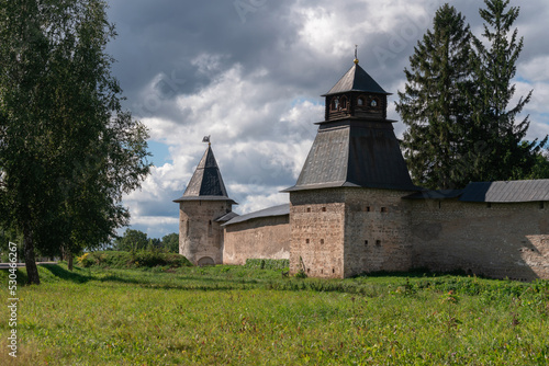 View of the wall of the Holy Dormition Pskov-Pechersk Monastery,  Izborskaya tower and Blagoveshchenskaya Tower on a sunny summer day, Pechory, Pskov region, Russia
