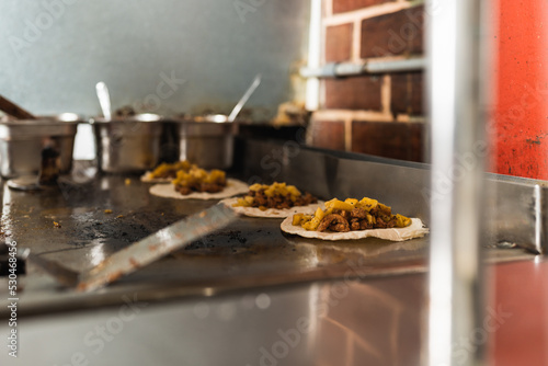 Kitchen with prepared corn and meat tacos