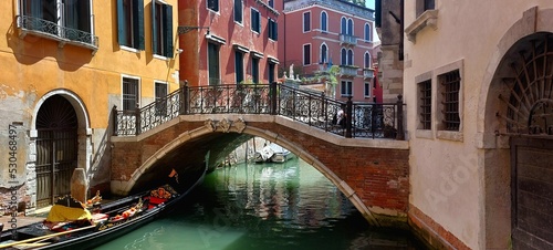 Bridge in Venice with Colorful Buildings and Blue Water © Sigon