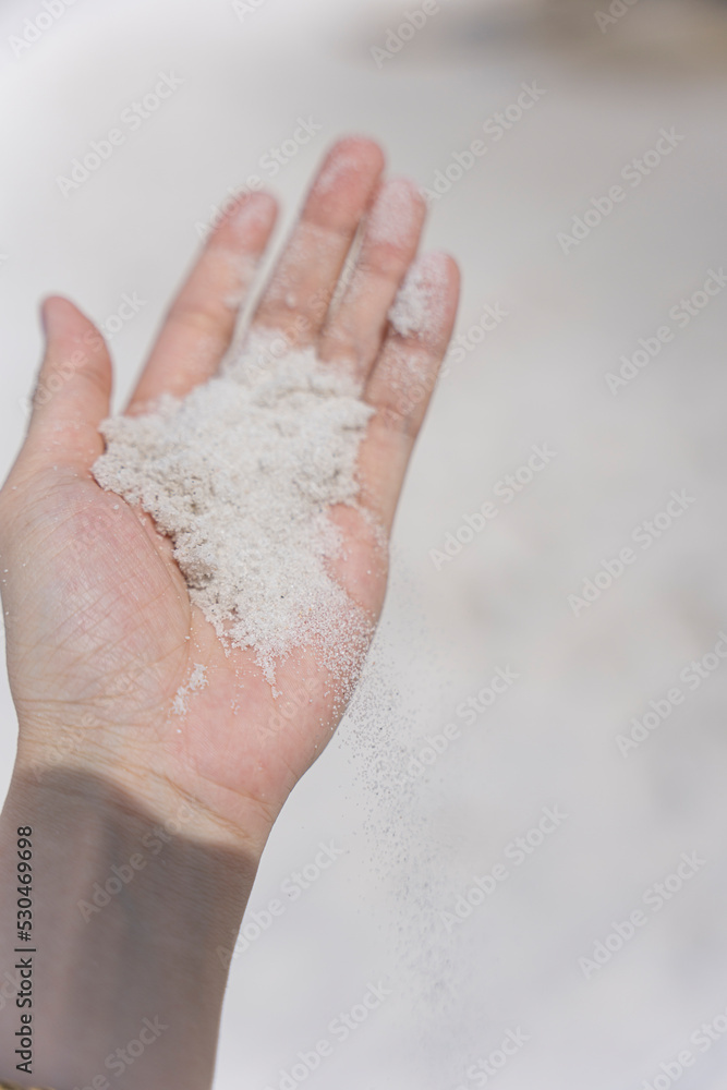 Fototapeta premium Hand Holding White Sand