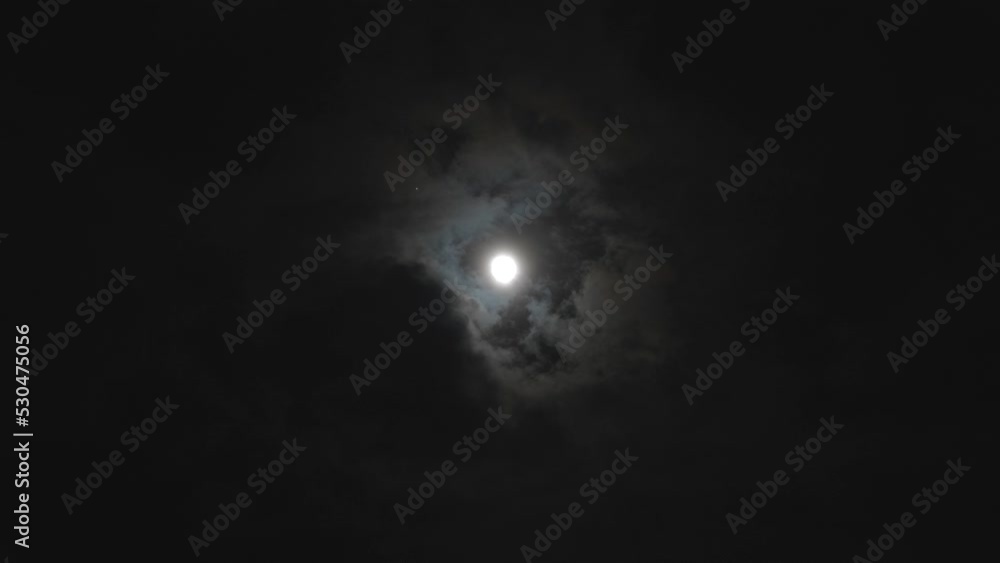 Shining full moon in cloudy at night with Jupiter the largest planet in solar system close to it, 4k real time footage. Shining full moon in cloudy at night with Jupiter the largest planet in solar system close to it, 4k real time footage.