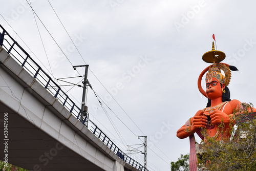 Big statue of Lord Hanuman near the delhi metro bridge situated near Karol Bagh, Delhi, India, Lord Hanuman statue touching sky photo