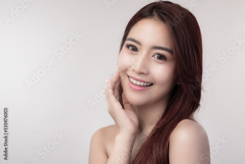 A half-body portrait of an Asian woman showing her beautiful face. Facial  skin and hair care concepts of beautiful Asian women.