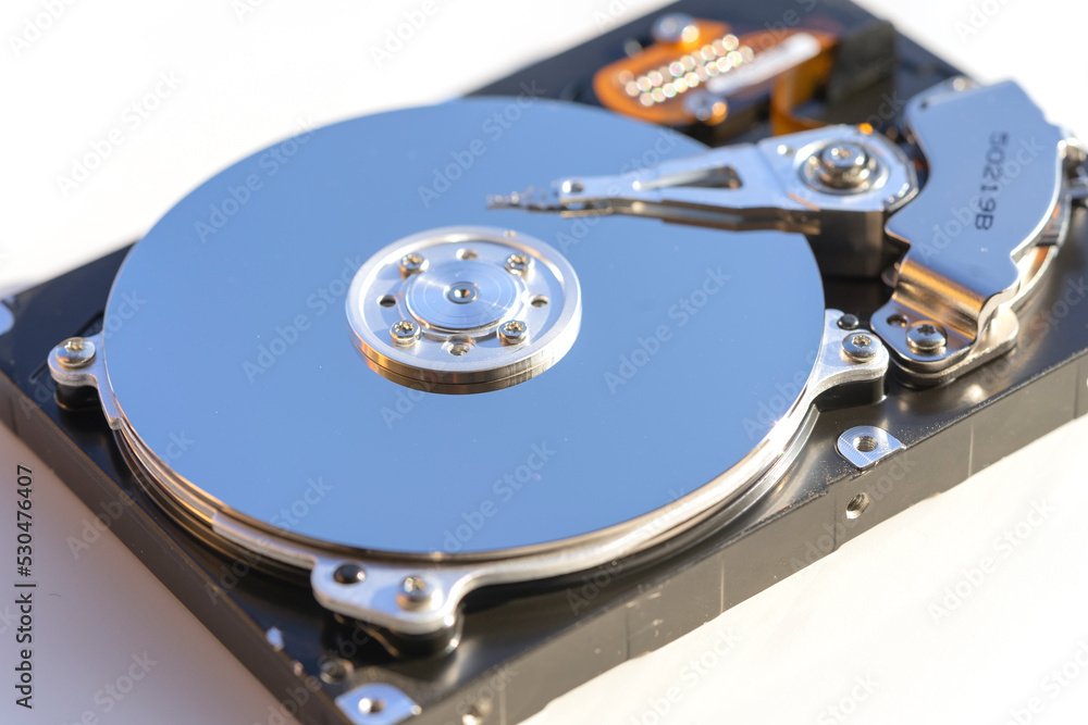 Disassembled hard drive from the computer, hdd with mirror effect. Opened hard drive from the computer hdd with mirror effects. Part of computer pc, laptop Disassembled hard drive from the computer, hdd with mirror effect. Opened hard drive from the computer hdd with mirror effects. Part of computer pc, laptop