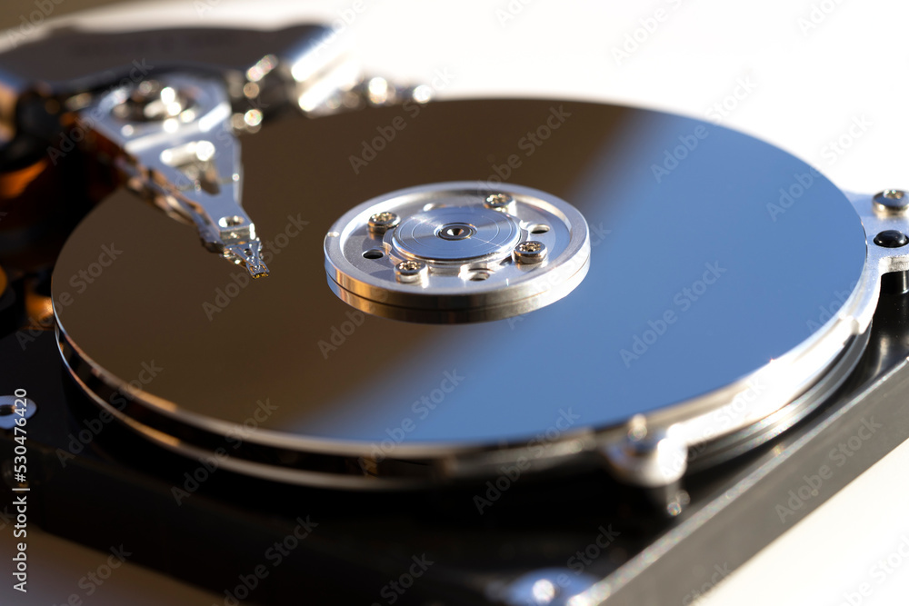 Disassembled hard drive from the computer, hdd with mirror effect. Opened hard drive from the computer hdd with mirror effects. Part of computer pc, laptop Disassembled hard drive from the computer, hdd with mirror effect. Opened hard drive from the computer hdd with mirror effects. Part of computer pc, laptop