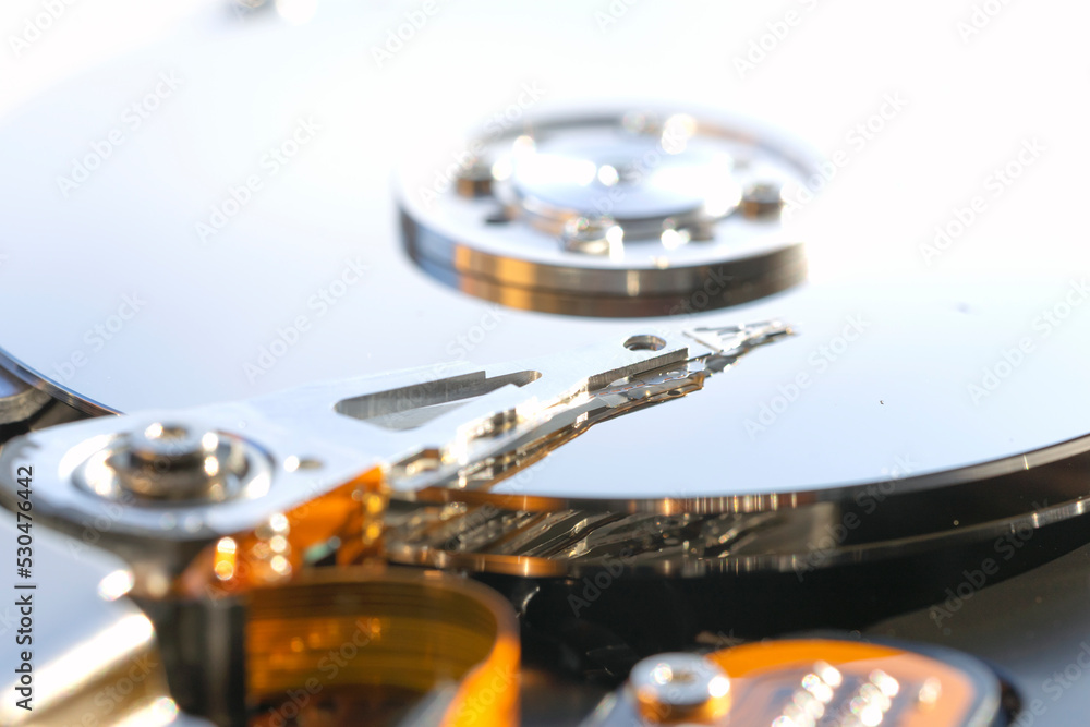 Disassembled hard drive from the computer, hdd with mirror effect. Opened hard drive from the computer hdd with mirror effects. Part of computer pc, laptop Disassembled hard drive from the computer, hdd with mirror effect. Opened hard drive from the computer hdd with mirror effects. Part of computer pc, laptop