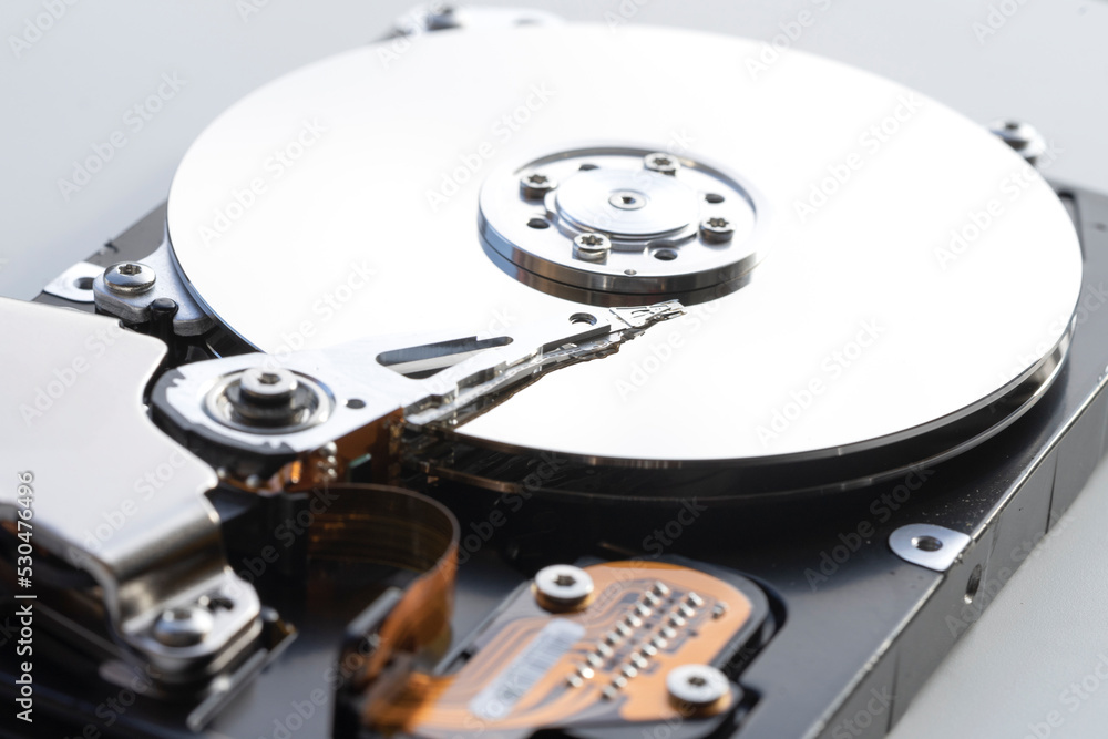 Disassembled hard drive from the computer, hdd with mirror effect. Opened hard drive from the computer hdd with mirror effects. Part of computer pc, laptop Disassembled hard drive from the computer, hdd with mirror effect. Opened hard drive from the computer hdd with mirror effects. Part of computer pc, laptop
