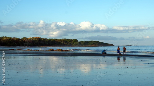 Fishermen on the beach at sunrise, in Tamarindo, Costa Rica