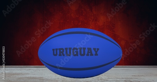 Composition of rugby ball decorated with text uruguay on black background