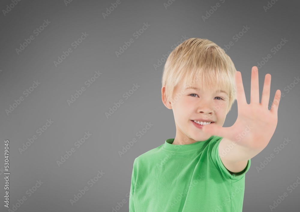 Portrait of caucasian boy showing stop sign with his hand against copy space on grey background Portrait of caucasian boy showing stop sign with his hand against copy space on grey background