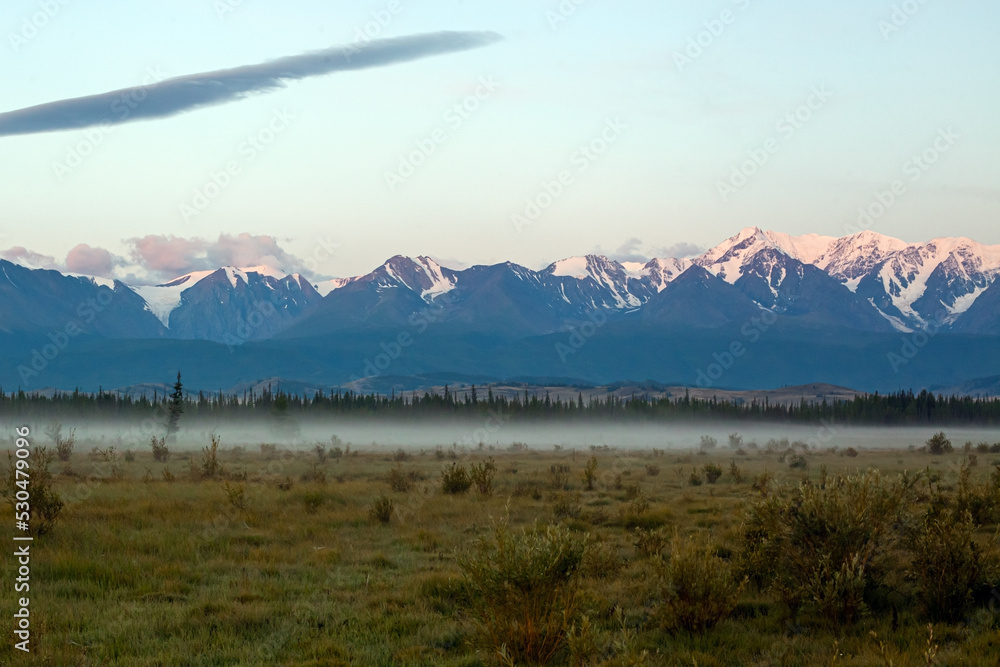 Steppe against the backdrop of mountains at dawn