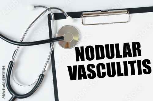 On a white surface, a stethoscope and a tablet with an inscription - Nodular vasculitis photo