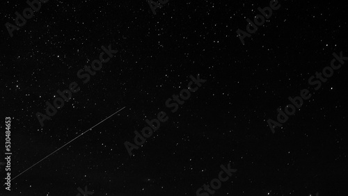 Astronomical long exposure photography of stars with a meteor or shooting star © Martin Erdniss