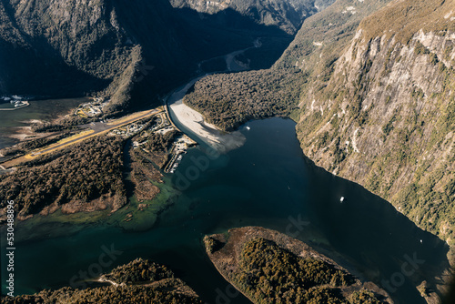 New Zealand. Milford Sound (Piopiotahi) from above - the head of the fiord with wharf and Milford Sound Airport.