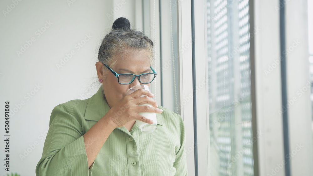Health concept of 4k Resolution. Asian old woman drinking milk in the house. Health concept of 4k Resolution. Asian old woman drinking milk in the house.