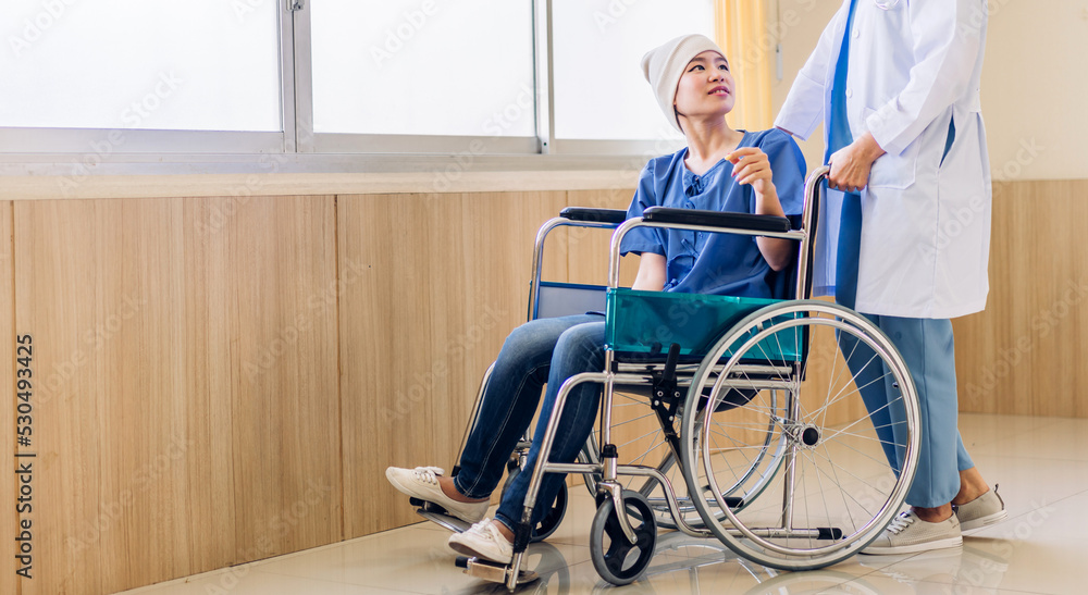 Professional medical doctor team with stethoscope in uniform discussing with patient woman with cancer cover head with headscarf of chemotherapy cancer in hospital.health care concept Professional medical doctor team with stethoscope in uniform discussing with patient woman with cancer cover head with headscarf of chemotherapy cancer in hospital.health care concept