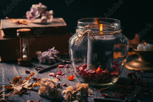 Fall candle decoration with dried leaves, autumn wooden home decor still life scented candle, autumn season interior decoration details photo