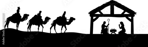 Traditional Christian Christmas Nativity Scene of baby Jesus in the manger with Mary and Joseph in silhouette and wise men