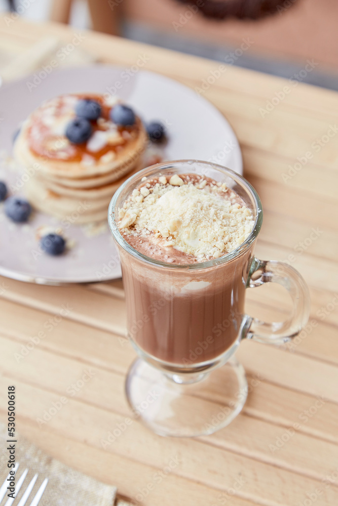 Dessert - belgian chocolate with ice cream in glass and traditional pancakes with syrup and blueberry outside. Delicious breakfast Dessert - belgian chocolate with ice cream in glass and traditional pancakes with syrup and blueberry outside. Delicious breakfast