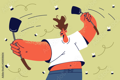 Unhappy man with fly swatters fight with bugs 
