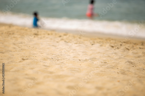 blurred of the kids playing on the beach © Ivan