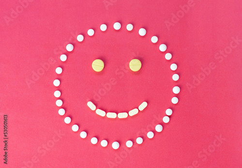 Pill arange icon face smile on red background. photo