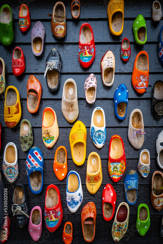 Wooden shoes painted with different regional motifs. Wooden clogs, typical traditional footwear from the Netherlands.
