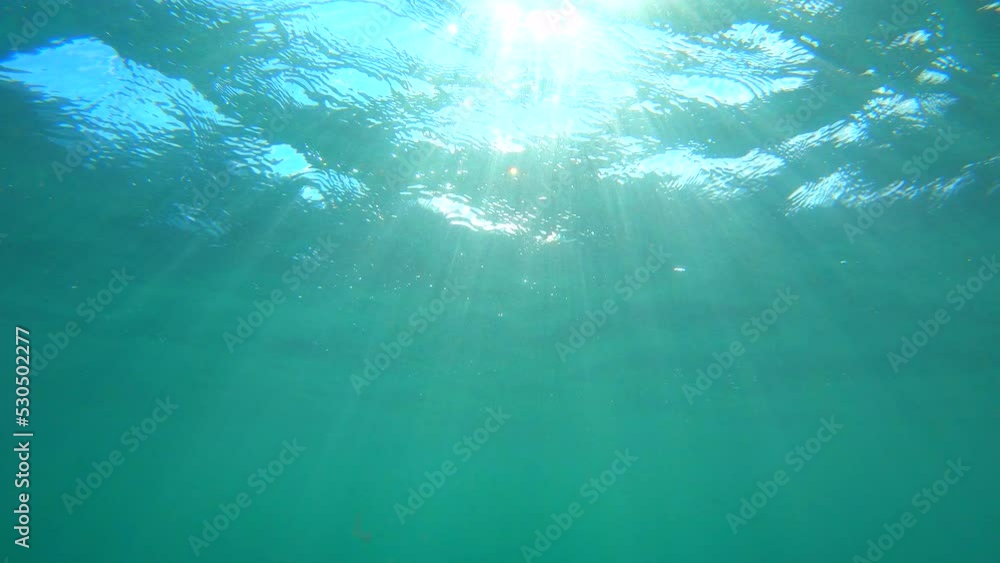 Sun Light Rays through under water's glittering. Underwater scene Sun Light Rays through under water's glittering. Underwater scene