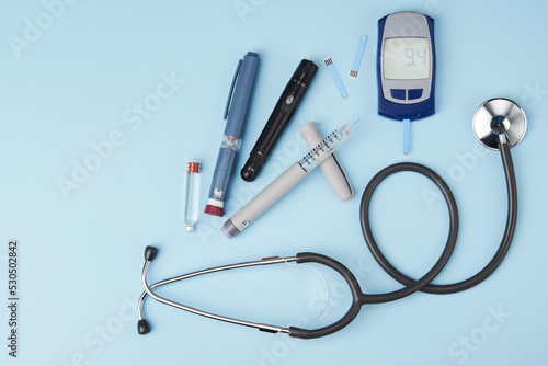 Diabetes concept with medical equipment on blue background