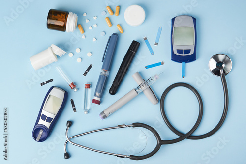 Diabetes concept with medical equipment on blue background
