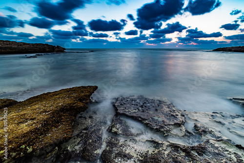 sunset over rocky coast Habonim beach Israel