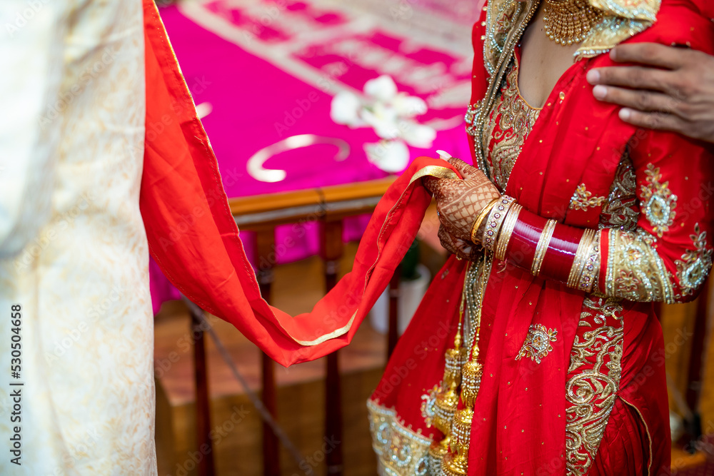 Indian Punjabi bride's red wedding outfit hands close up